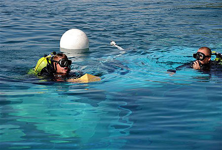 Police divers search for missing persons at the wreckage of a sunken boat in Lake Ohrid in southwestern Macedonia, on Saturday, Sept. 5, 2009